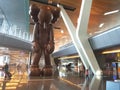 Artwork on show at Doha airport, picture of the monumental wooden art piece called SMALL LIE by American artist KAWS