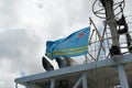 Aruba flag flutters on the wind on navigational mast of bridge of merchant container vessel during mooring in Barcadera.