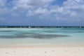 Aruba, Renaissance Island, Caribbean Sea. Sunny beach with white sand, coconut palm trees and turquoise sea. Summer vacation,