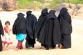 ARUGAM BAY, AUGUST 13: A group of Muslim women walking down the beach with a little girl Royalty Free Stock Photo