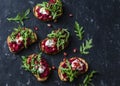 Arugula, beet hummus grilled sandwiches on dark background, top view. Delicious healthy appetizer or snack.