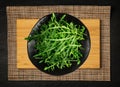 Arugula on Black Plate, Fresh Arugula, Ruccola Leaves, Rucola, Eruca or Garden Roquette Salad