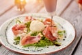 Arugula and prosciutto salad decorating with sauce. Royalty Free Stock Photo