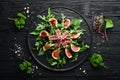 Arugula salad, tuna fillet and figs with blackberry berries. Menu. Free copy space. Royalty Free Stock Photo