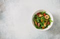 Arugula, tomatoes and shrimps salad on blue stone background Royalty Free Stock Photo