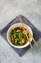Arugula, tomatoes and shrimps salad on blue stone background Royalty Free Stock Photo