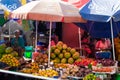 Arusha, Tanzania; 08/06/2019: Fruit stand with colorful parasol in a market of Arusha, Tanzania