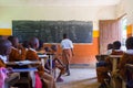 Children in uniforms in primary school classroom listetning to teacher in rural area near Arusha, Tanzania, Africa.