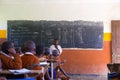 Children in uniforms in primary school classroom listetning to teacher in rural area near Arusha, Tanzania, Africa.