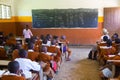 Children in uniforms in primary school classroom listetning to teacher in rural area near Arusha, Tanzania, Africa.