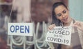As Covid-19 restrictions ease, restaurant owner unsticks the closure sign putting open sign on a window Royalty Free Stock Photo