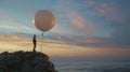As dusk settles over the horizon a figure in a lab coat stands on a rocky cliff launching a weather balloon into the