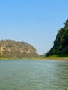 Landscape view of the river, green hills, and blue sky. Natural feel.