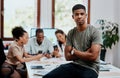 As hard working as a team should be. Portrait of a confident young businessman with his team having a meeting in the Royalty Free Stock Photo