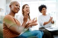 As long as we work together, we will celebrate many more successes. a group of businesswomen applauding in an office.