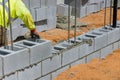 As a mason man is mounting a wall of aerated concrete blocks, he was laying the framework for the wall