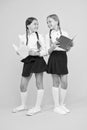 As the Page Turns. little girls in school uniform. reading story. childrens literature. kids learning grammar. back to Royalty Free Stock Photo