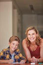 As a parent, Im also an educator. a young woman helping her son with his homework at home. Royalty Free Stock Photo