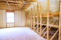 As part of construction process, thermal foam insulation is installed under roof of a new frame house Royalty Free Stock Photo