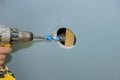 As part of renovation of house, a hole needs to be drilled through wall to lay cable among beams Royalty Free Stock Photo