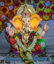 Portrait , closeup view of decorated and garlanded idol of Hindu God Ganesha in Pune ,Maharashtra, India.