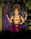 Closeup , portrait view of decorated and garlanded idol of Hindu God Ganesha in Pune ,Maharashtra, India.