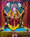 Closeup , portrait view of decorated and garlanded idol of Hindu God Ganesha in Pune ,Maharashtra, India.