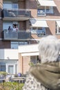 As a result of the Corona virus this woman can not really say goodbye and just wave to her demented mother in the nursing home, Th Royalty Free Stock Photo