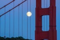 The June 2022 full moon rising alongside the north tower of the Golden Gate Bridge in San Francisco. Royalty Free Stock Photo