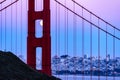 Pink blue sky and the full moon is visible through the north tower of the Golden Gate Bridge in San Francisco Royalty Free Stock Photo