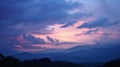 As the sun sets behind the mountains the sky becomes a canvas of pastel hues creating a serene backdrop for a peaceful