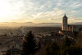 As the sun sets over the medieval walls of Girona in Catalunya, Spain, the city comes alive with warm, golden light