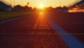 As the sun sets over the stadium the rubberized tracks are illuminated in a soft golden light. The vibrant colors of the