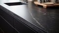 A close-up of Absolute Black Honed granite, displaying a matte black finish with a refined texture
