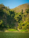 A river with trees and mountains in the background. Mountain river in the jungle. Nature landscape background. Royalty Free Stock Photo