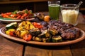 asado mixed grill with grilled veggies on a rustic table