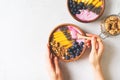 Asai bowl granola oatmeal with mango, blueberry and chia seeds in wooden plate on white background