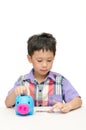 Asain boy counting coins from piggybank Royalty Free Stock Photo