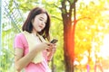 Asain girl texting while taking a break before exercise in city Royalty Free Stock Photo