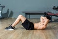 Asain handsome black hair doing exercise with crunches .to strengthen the abdominal muscles in fitness center