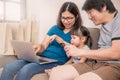 Asain parents and their daughter are doing shopping online using laptop Royalty Free Stock Photo