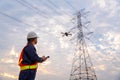 Asian technician use drone to fly inspections at the electric power station to view the planning work by producing electricity