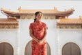 Asain woman wearing china tradition suit standing against china temple background