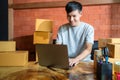 Asain young man start small business online with e-commerce. The seller prepares the delivery box for the customer. Additional