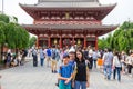 An Asian family stands in front of the famous Asakusa temple`s big red lantern for their family photo