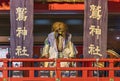 Japanese dancer in kimono dancing with an eagle mask in Ootori shrine during the Tori-no-Ichi fair.