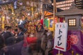 Toilet sign board in front of a stone lantern of Tori-no-Ichi Fair held in Ootori shrine.