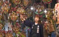 Young female merchant in a stall of auspicious rakes in the Tori-no-Ichi Fair of Ootori shrine.