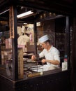 Asakusa, Tokyo / Japan - 12/23/2015 : A man making traditional Japanese sweets using traditional tools Royalty Free Stock Photo