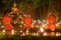 Asalha Puja Day ,Monks pray to buddha statue .